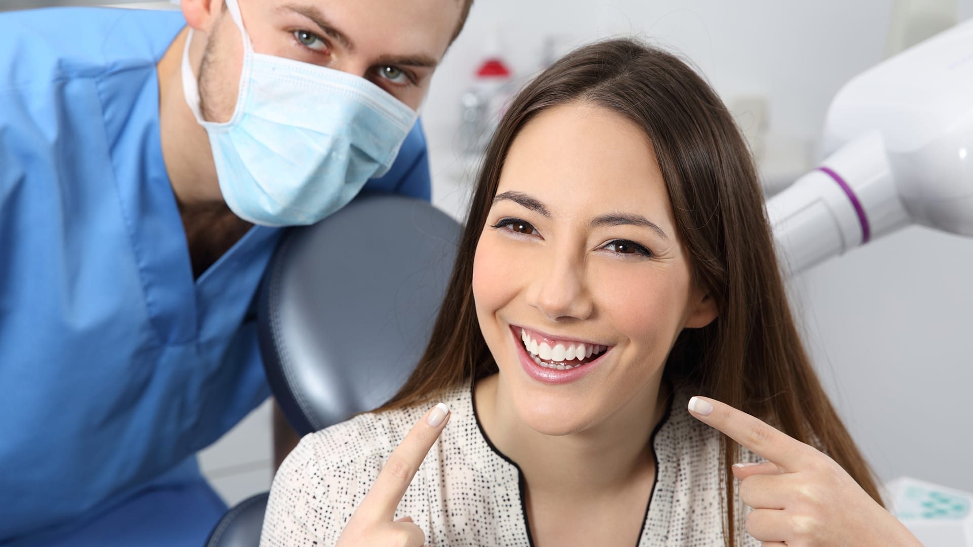 Satisfied dentist patient showing her perfect smile in a consultation