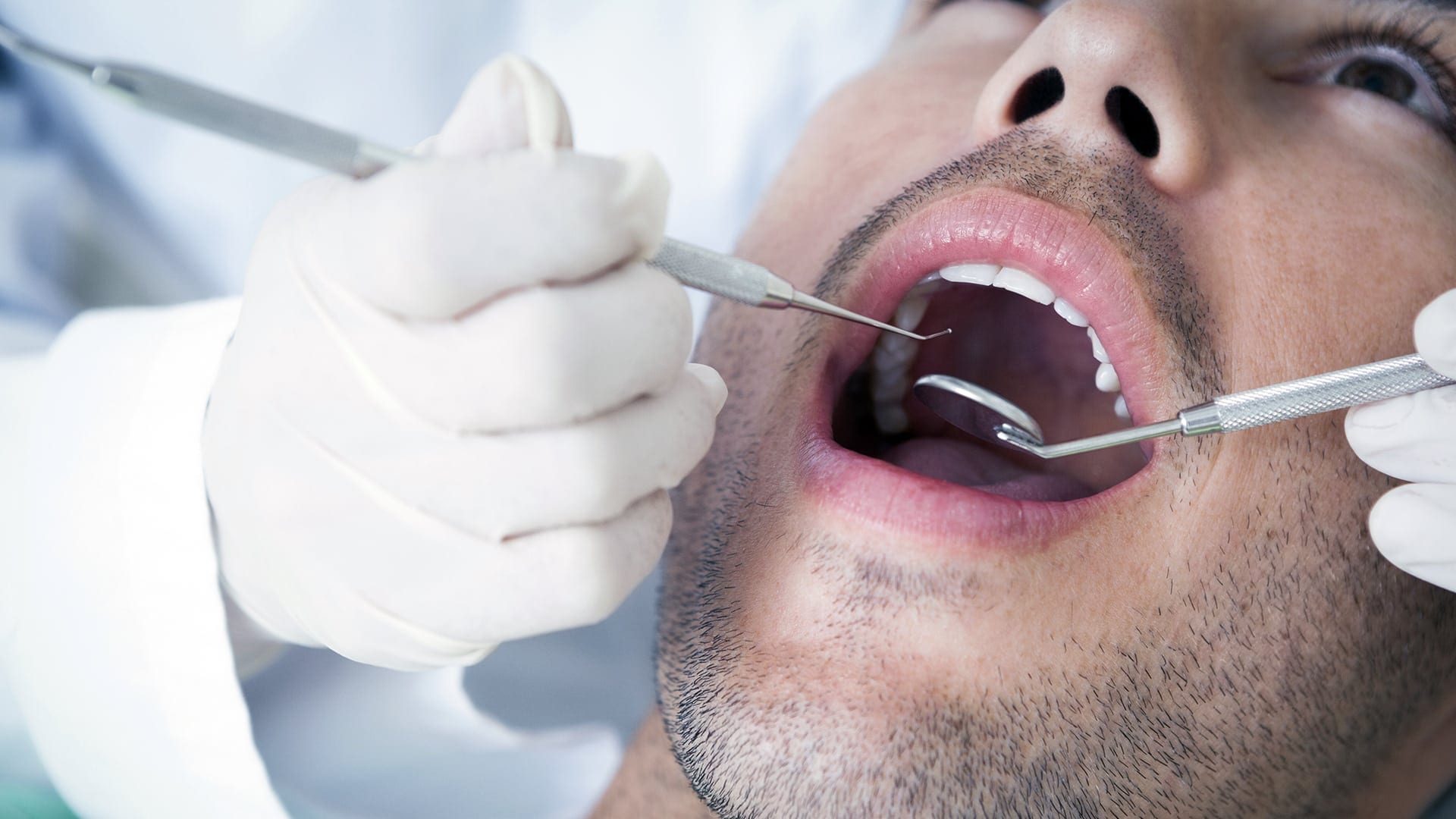Close up of man having his teeth examined
