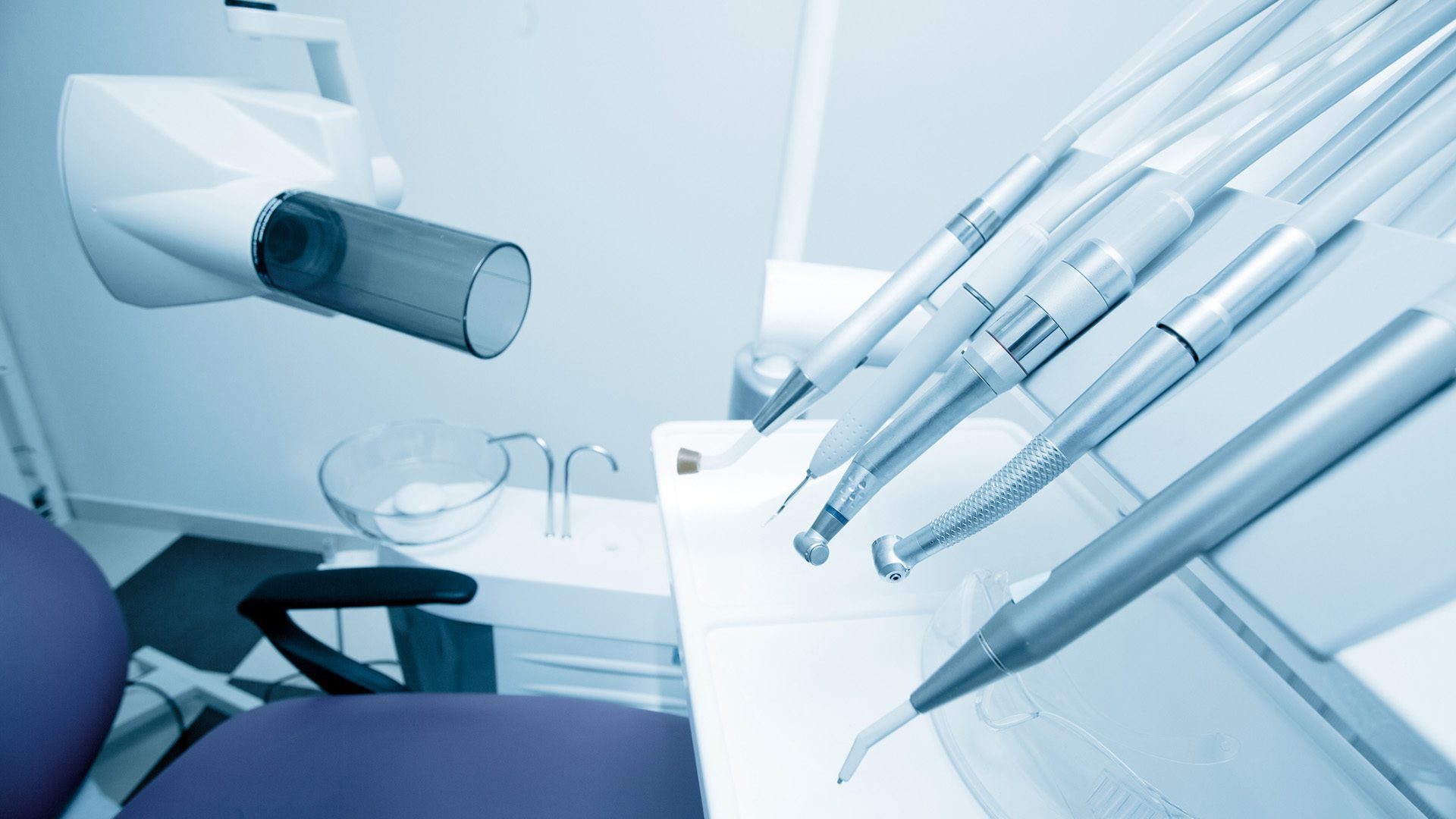 Tools of dentist in a dentist office. Blue tone.